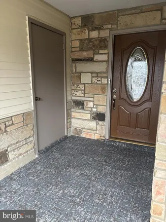 a front view of a house with a door and a window