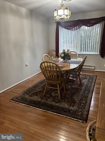 a dining room with furniture and wooden floor