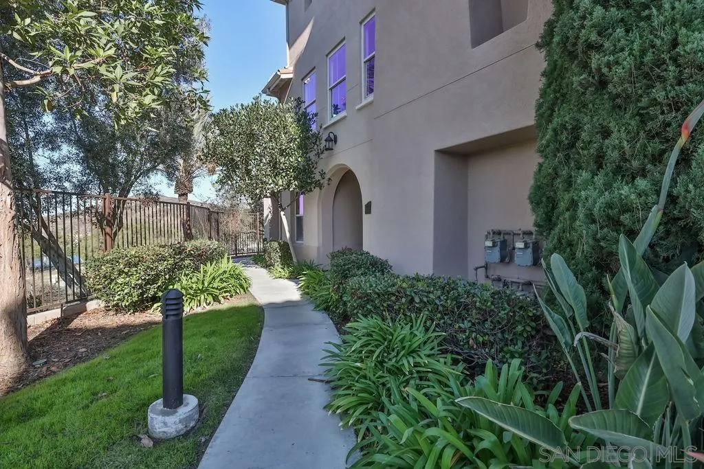 2297 Huntington Point Road, Unit 162 Chula Vista, CA 91914 - Photo 3 of 59 a front view of a house with a yard and potted plants