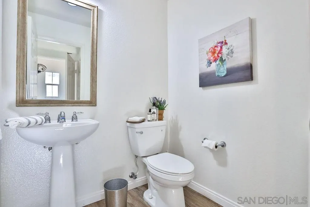 2297 Huntington Point Road, Unit 162 Chula Vista, CA 91914 - Photo 35 of 59 a bathroom with a toilet sink and mirror