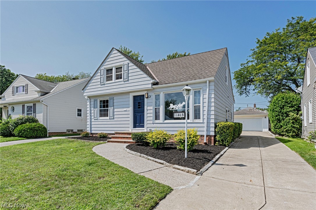 View of front of house with garage and a front lawn