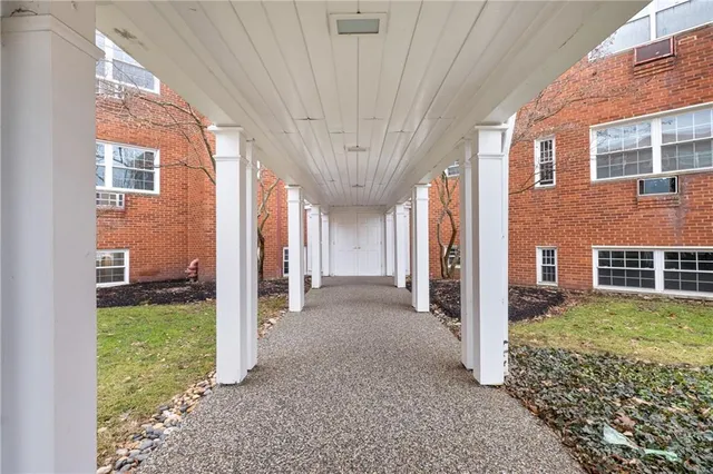 a view of a house with a big yard and large tree