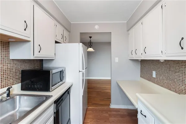 a kitchen with stainless steel appliances granite countertop a sink and a microwave