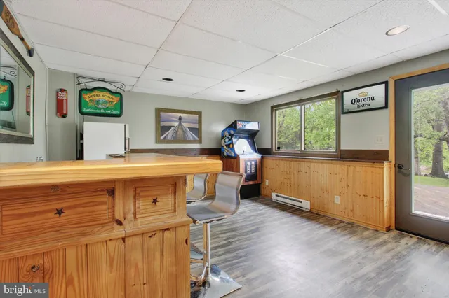 a view of a living room and window with wooden floor