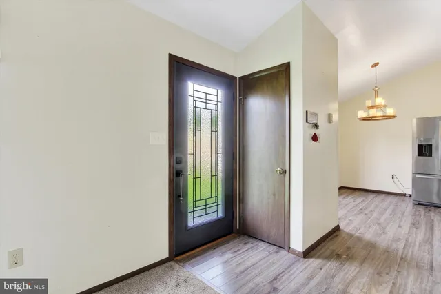 an empty room with wooden floor and a window
