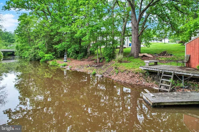 an aerial view of residential house with outdoor space and trees all around