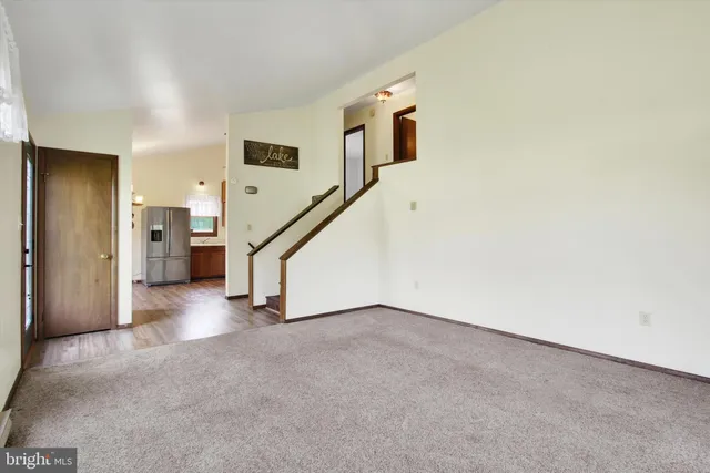 a view of an empty room with stairs