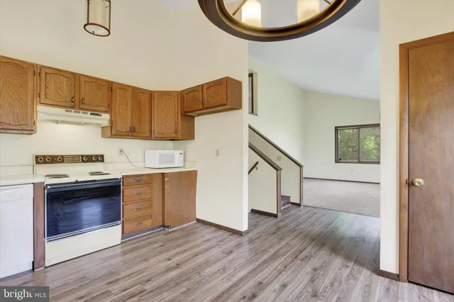 a kitchen with wooden floors and a stove top oven