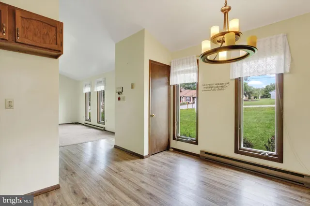 a view of an entryway with wooden floor