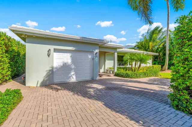 a front view of a house with a yard and a garage