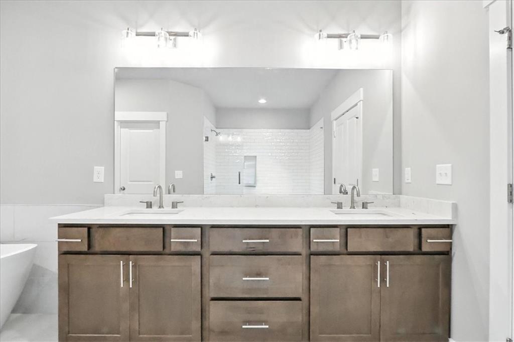 95 Old Town Road Dacula, GA 30019 - Photo 45 of 74 a bathroom with a sink a toilet a mirror and vanity