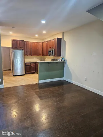 a kitchen with stainless steel appliances a refrigerator and a sink