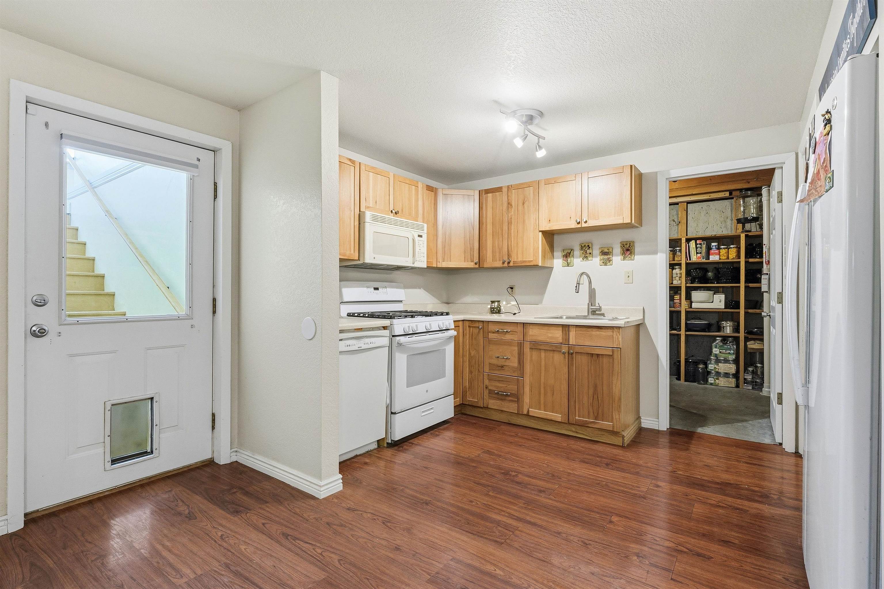 176-29 1/2 A 1/2 Road Grand Junction, CO 81503 - Photo 22 of 41 a kitchen with a white cabinets and wooden floor