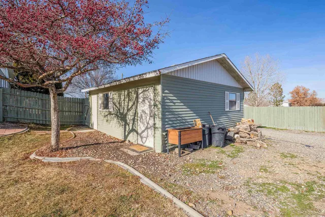 a backyard of a house with table and chairs