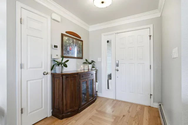a view of an entryway with wooden floor