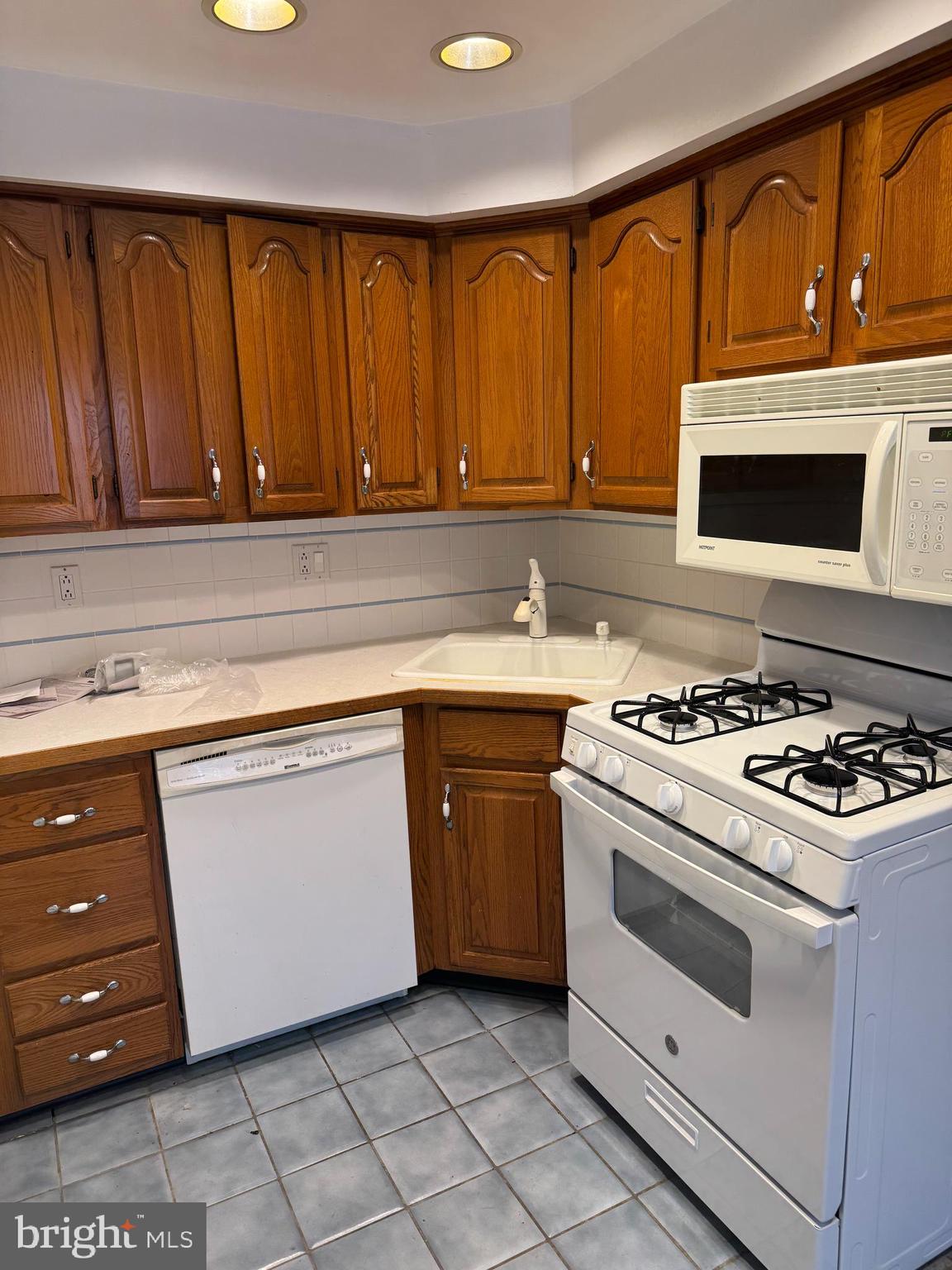 251 Revere Road Clifton Heights, PA 19018 - Photo 5 of 23 a kitchen with a stove and a microwave