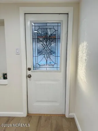 a view of a kitchen with wooden floor