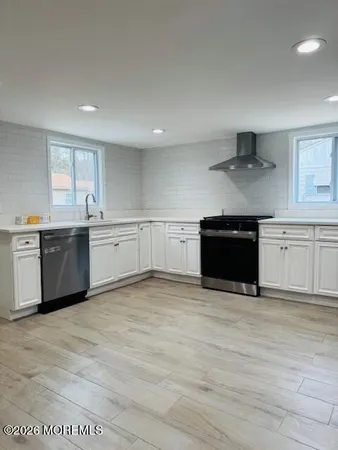 a kitchen with stainless steel appliances granite countertop a refrigerator and a stove top oven