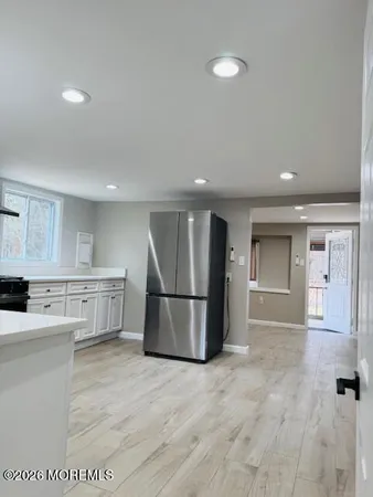 a view of a room with wooden floor and cabinet