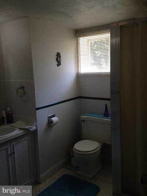 5435 Whitfield Chapel Road Lanham, MD 20706 - Photo 11 of 16 a white toilet sitting next to a bathroom sink
