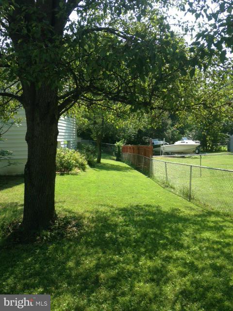 5435 Whitfield Chapel Road Lanham, MD 20706 - Photo 13 of 16 a backyard of a house with a yard and outdoor seating