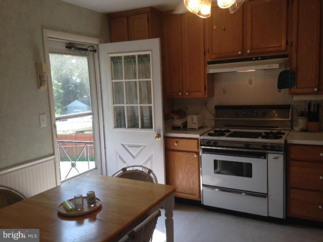 5435 Whitfield Chapel Road Lanham, MD 20706 - Photo 5 of 16 a kitchen with a stove and a microwave