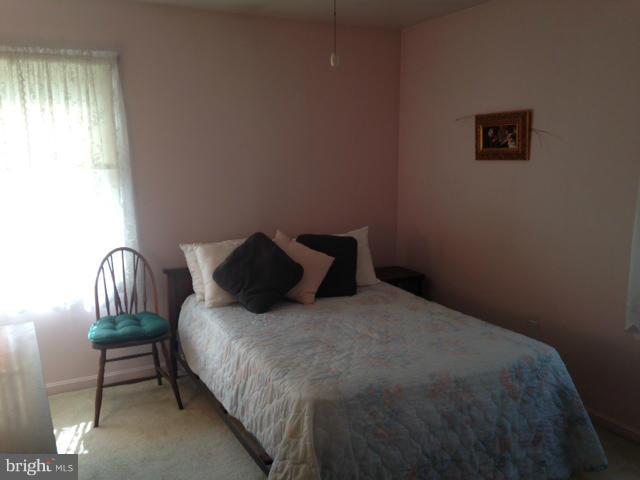 5435 Whitfield Chapel Road Lanham, MD 20706 - Photo 6 of 16 a bed sitting in a bedroom next to a window