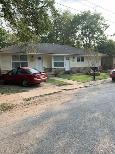 a front view of a house with a garden and plants