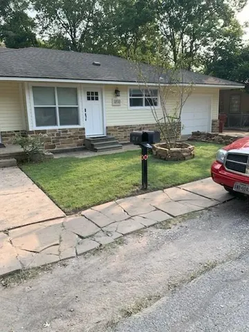 a front view of a house with garden