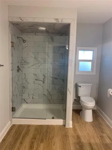 a bathroom with a toilet and a shower