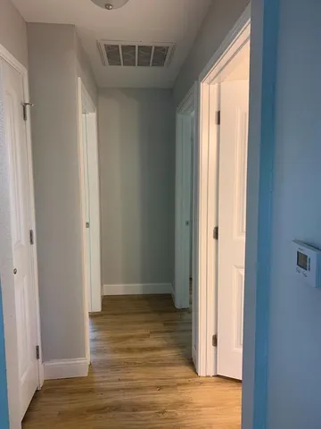 a view of hallway with wooden floor