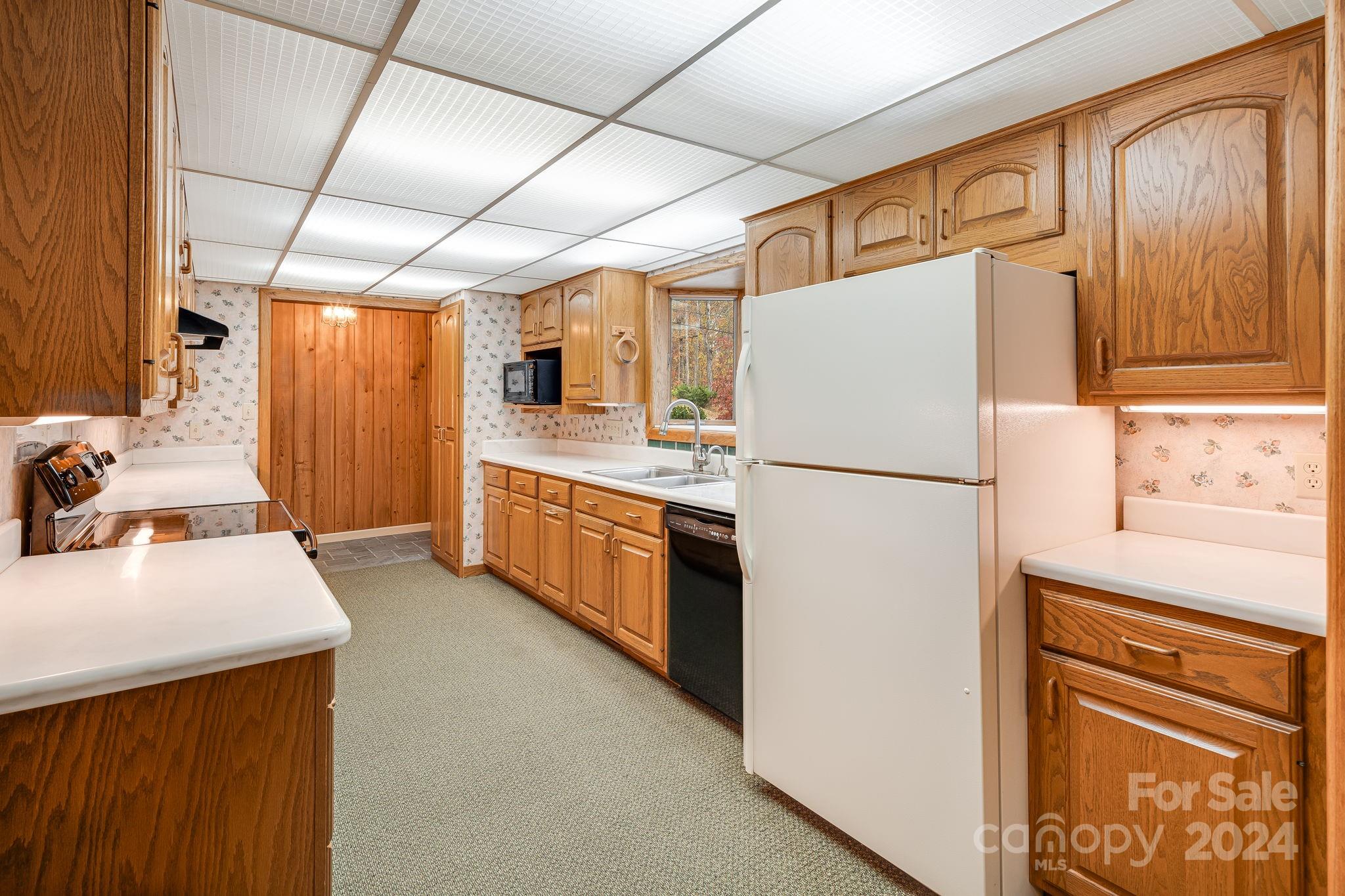 56 Whitaker View Road Fairview, NC 28730 - Photo 13 of 34 a kitchen with stainless steel appliances a refrigerator sink and white cabinets