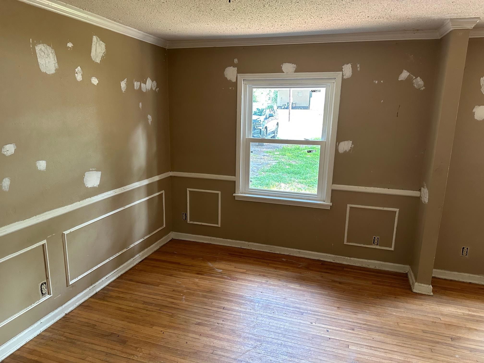 4483 Yale Road Memphis, TN 38128 - Photo 4 of 10 a view of an empty room with wooden floor and a window