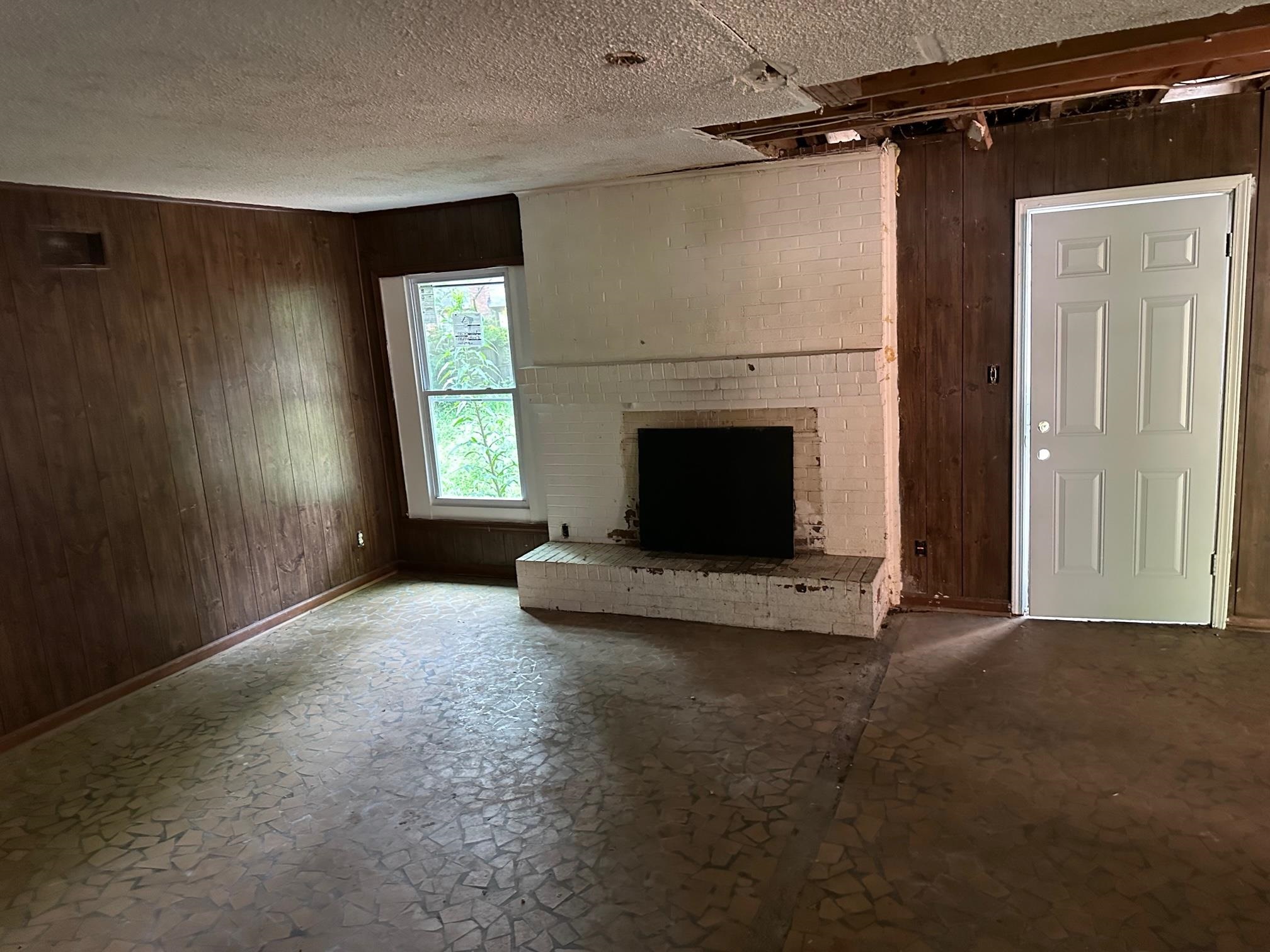 4483 Yale Road Memphis, TN 38128 - Photo 5 of 10 a view of an empty room with a fireplace and a window