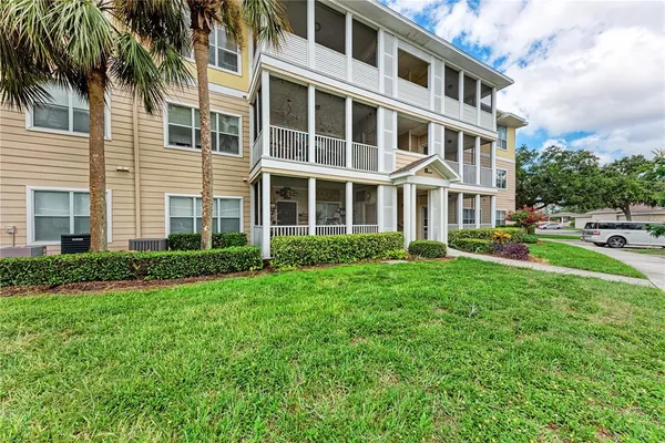 a front view of a residential apartment building with a yard