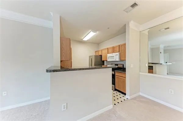 a kitchen with stainless steel appliances a refrigerator and a stove top oven
