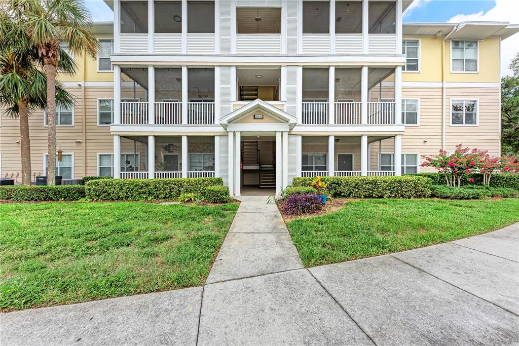 4802 51st Street West, Unit 1122 Bradenton, FL 34210 - Photo 2 of 37 front view of a brick house with a yard