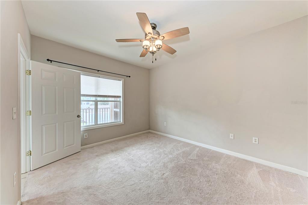 4802 51st Street West, Unit 1122 Bradenton, FL 34210 - Photo 24 of 37 an empty room with windows and fan