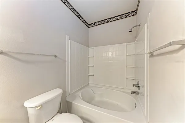 a bathroom with a toilet and shower