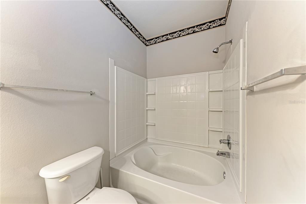 4802 51st Street West, Unit 1122 Bradenton, FL 34210 - Photo 28 of 37 a bathroom with a toilet and shower