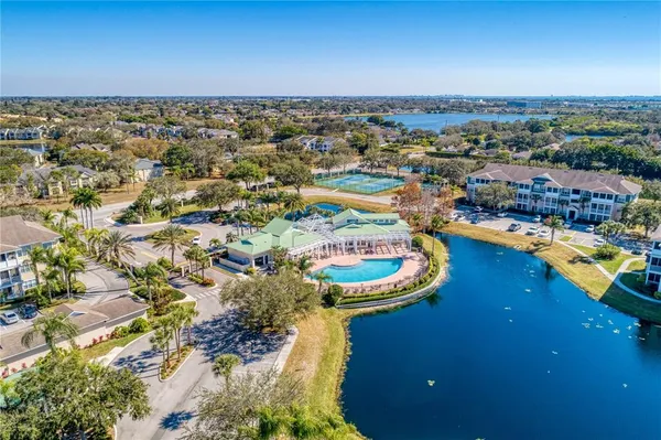 an aerial view of a residential houses with outdoor space and swimming pool