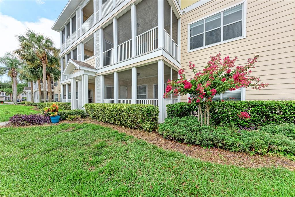 4802 51st Street West, Unit 1122 Bradenton, FL 34210 - Photo 4 of 37 a view of a house with many windows and flower plants