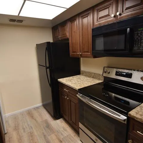 a kitchen with a stove microwave and refrigerator