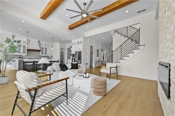 a view of dining room and kitchen with furniture wooden floor kitchen chandelier