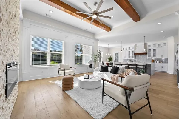 a kitchen with kitchen island a dining table chairs sink and cabinets