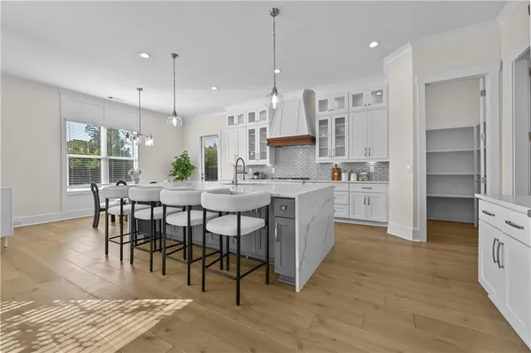 a kitchen with stainless steel appliances kitchen island granite countertop a sink and cabinets