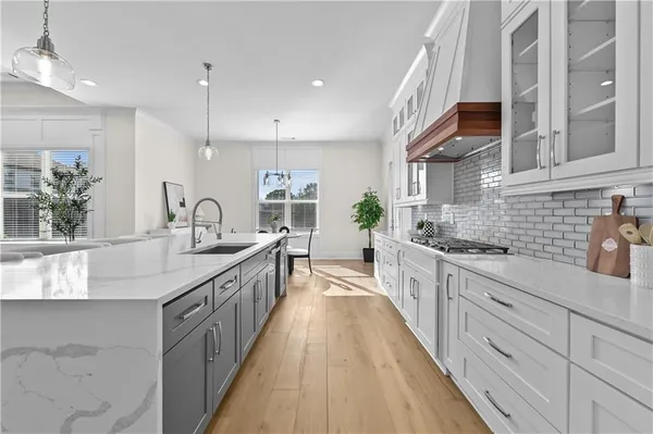 a large kitchen with stainless steel appliances lots of counter space and a sink