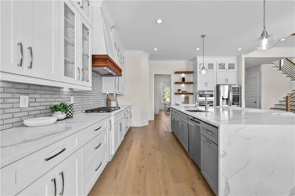 a dining room with furniture a chandelier and wooden floor