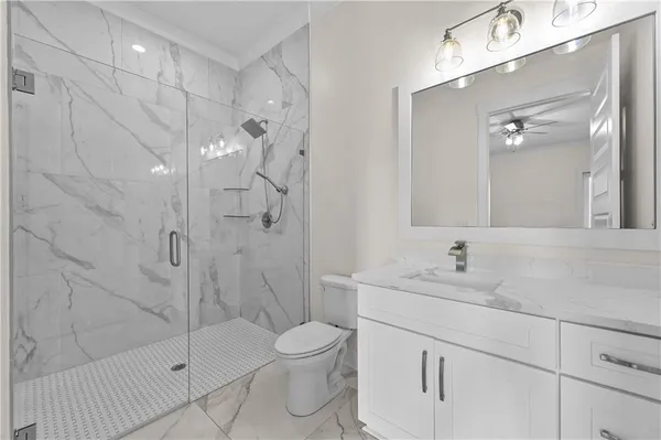 a living room with furniture a fireplace and a ceiling fan