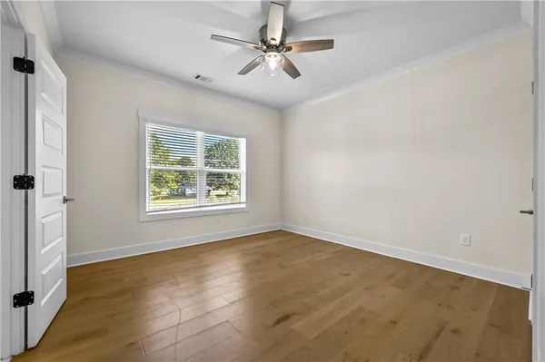 wooden floor in an empty room with a window